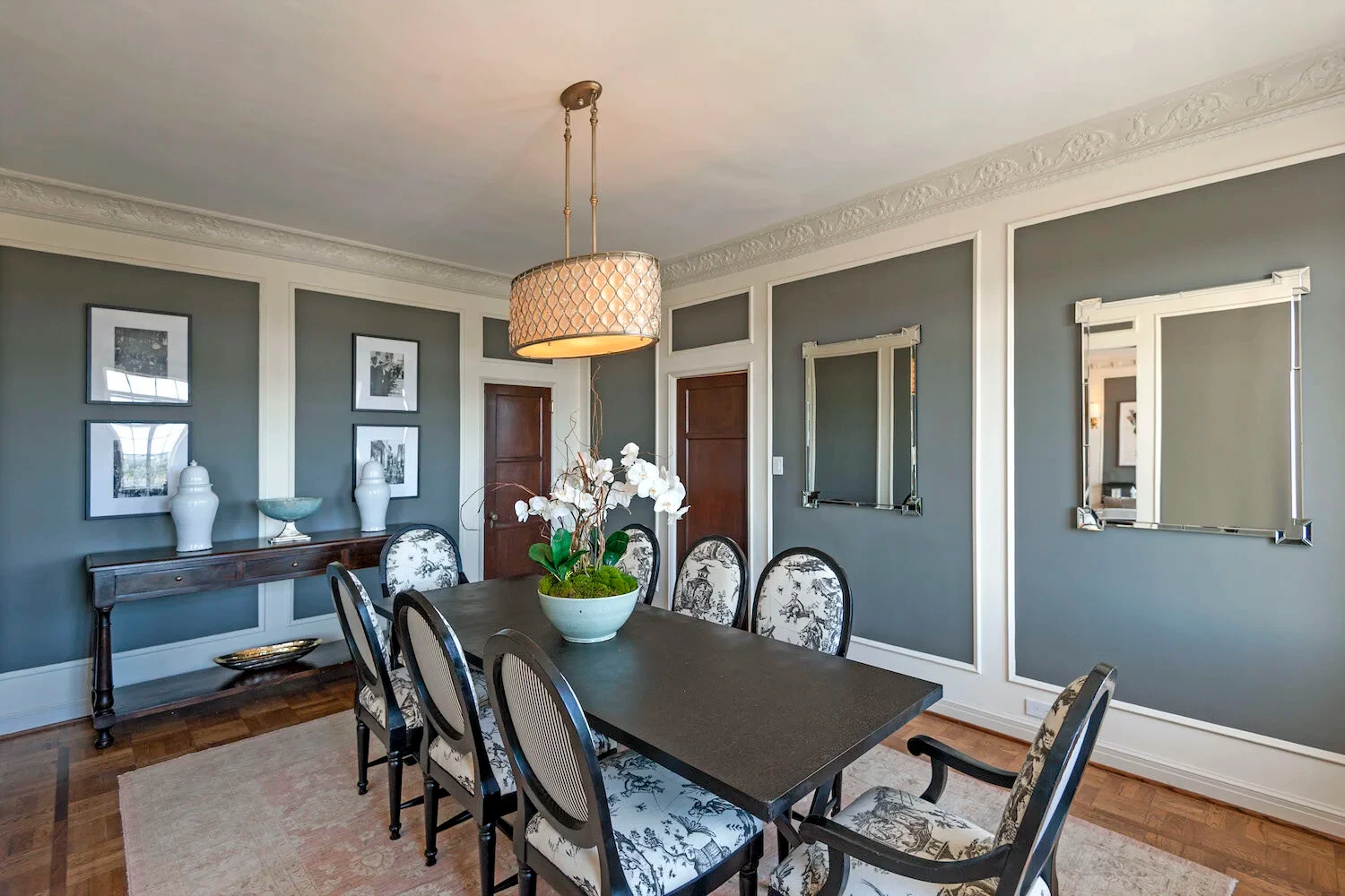 El Royale — dining room with grey walls, white wainscoting and parquet floors