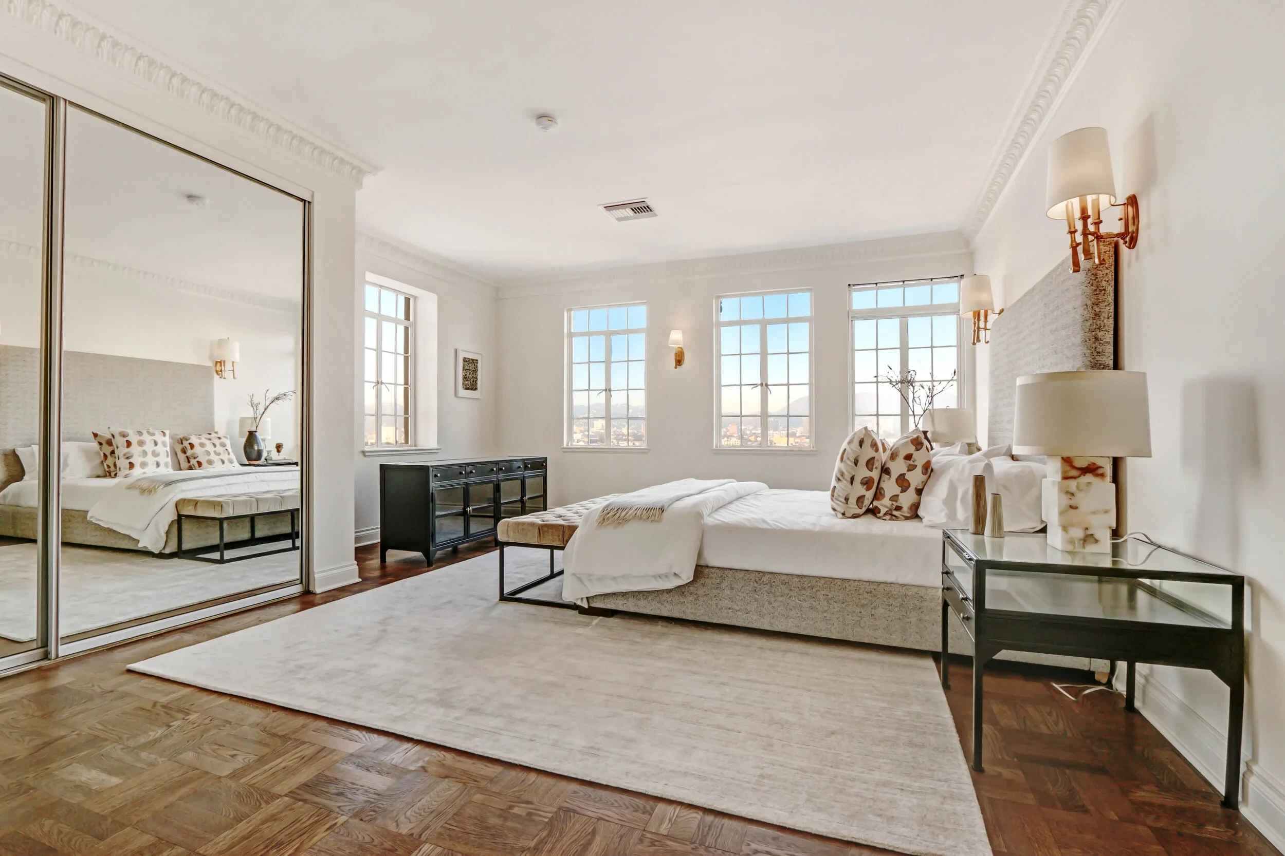 El Royale — master bedroom with warm tones and panoramic city views