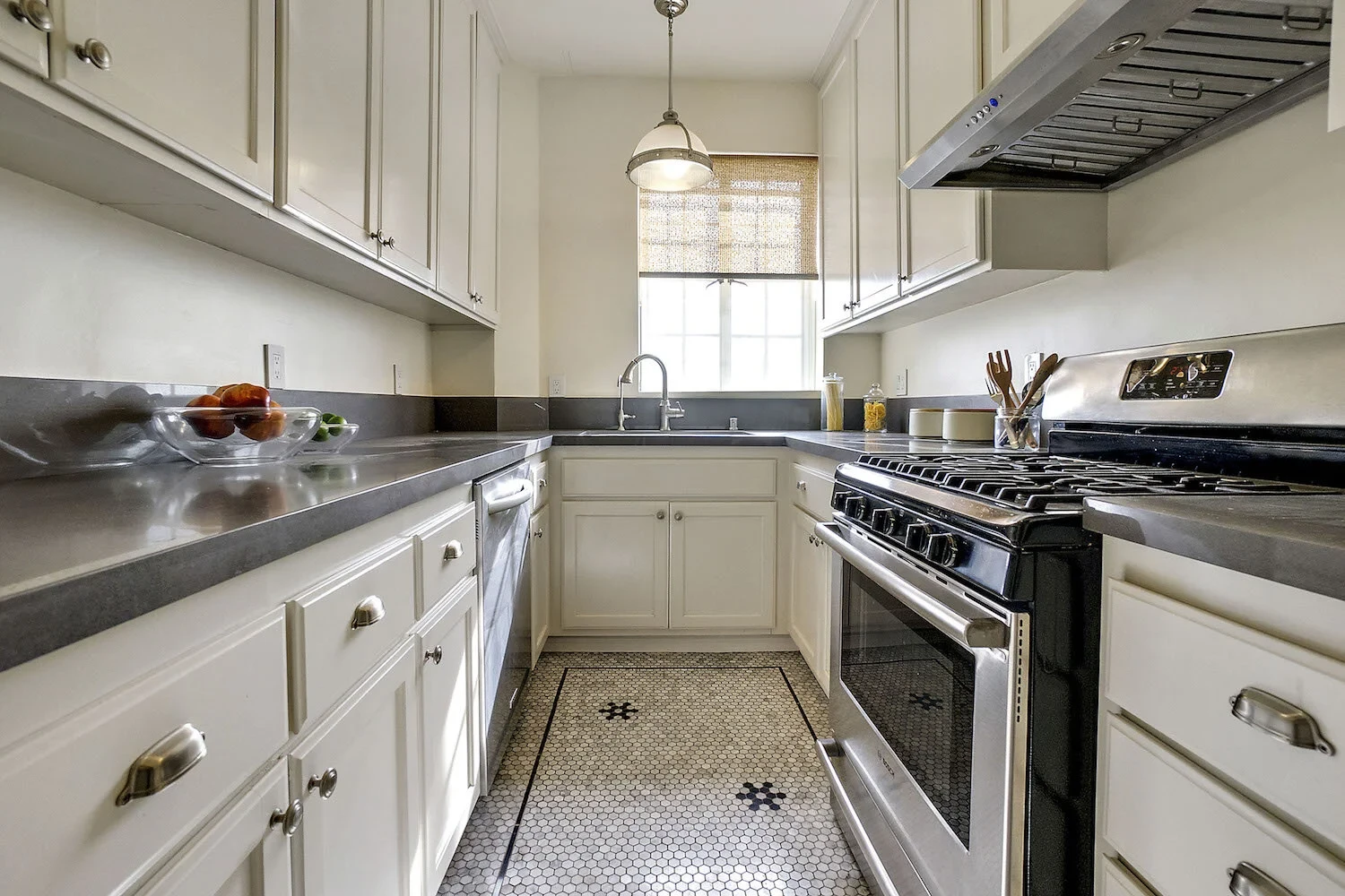 El Royale — classic galley kitchen with white cabinetry and hex tile floors